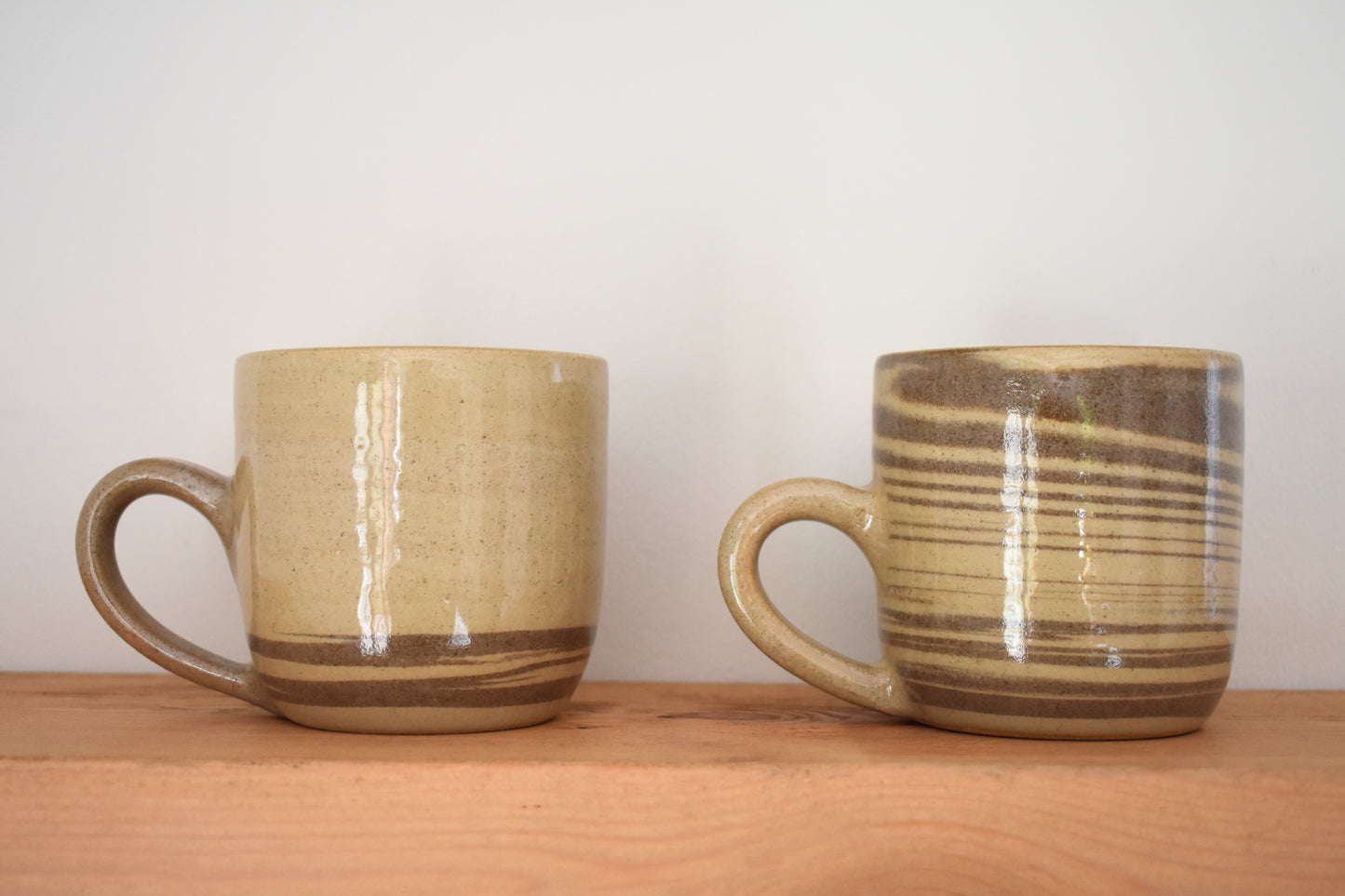 Ceramics by Sunny stoneware mugs with brown and beige marble pattern.