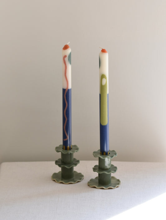 A pair of two Pygmalion London Terracotta dinner candles with Moroccan inspired design in blue and off-white.