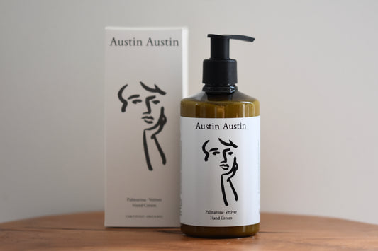 Austin Austin Organic palmarosa and vetiver hand cream with face outline artwork by Christian Newby on the bottle and box.