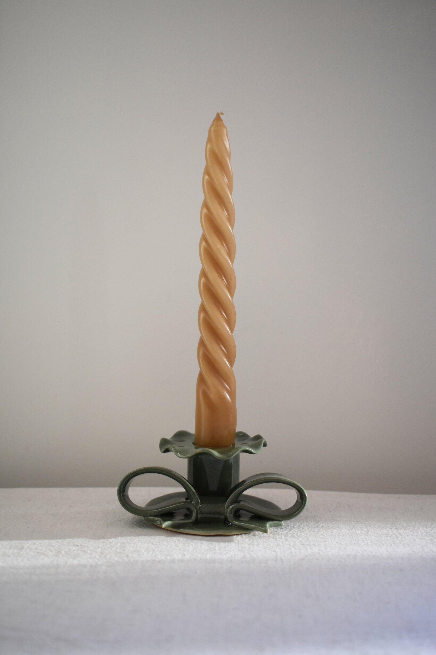 Superfluities stoneware ceramic Bow Candlestick with frill in green.