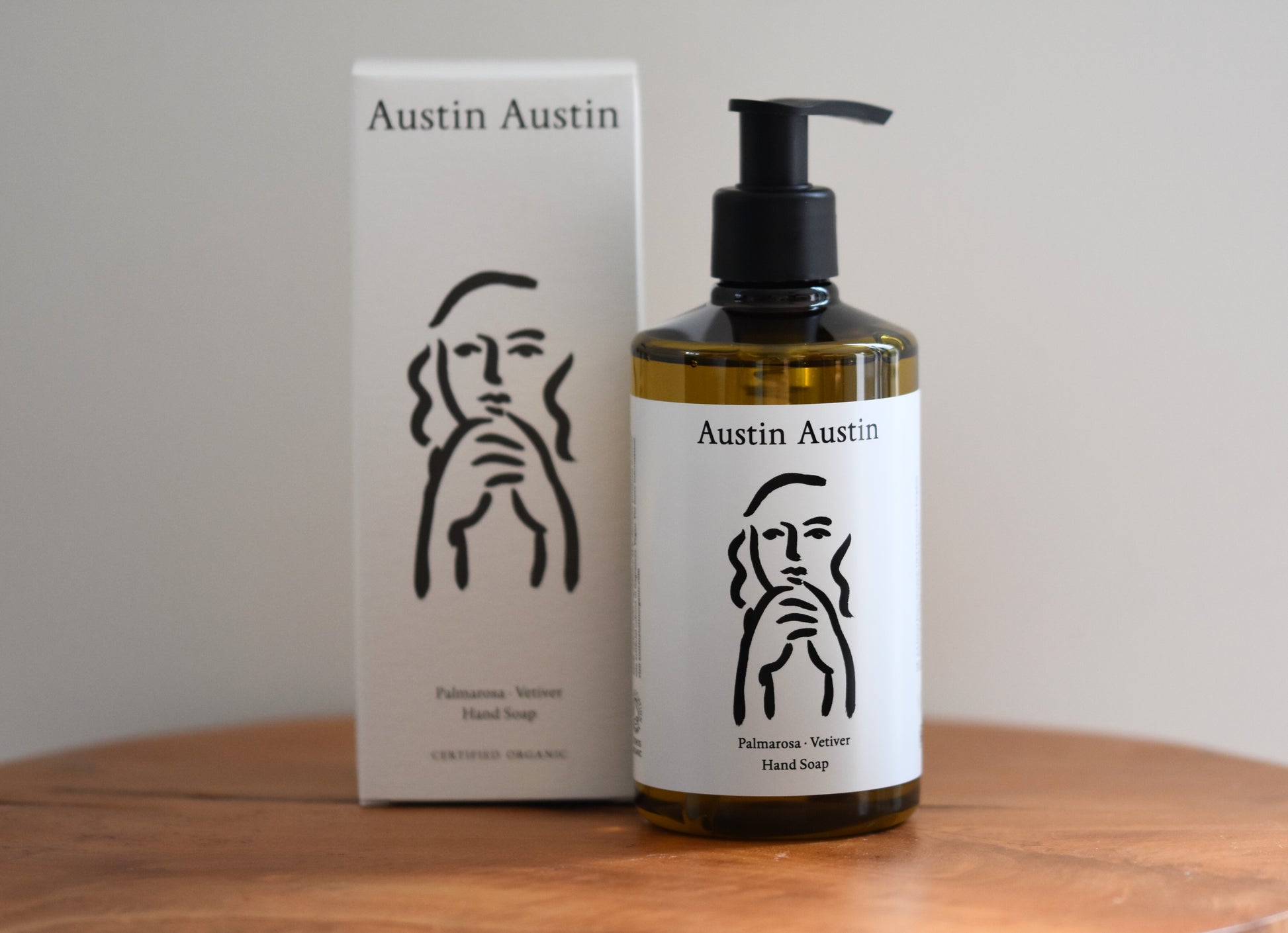 Austin Austin Organic palmarosa and vetiver hand soap with face outline artwork by Christian Newby on the bottle and box.