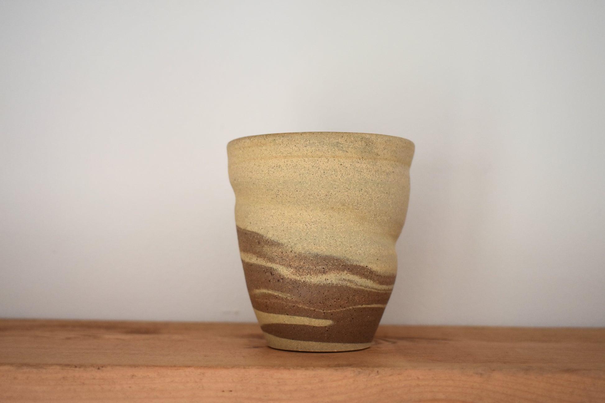 Ceramics by Sunny stoneware spiral cup with beige and brown marble pattern.