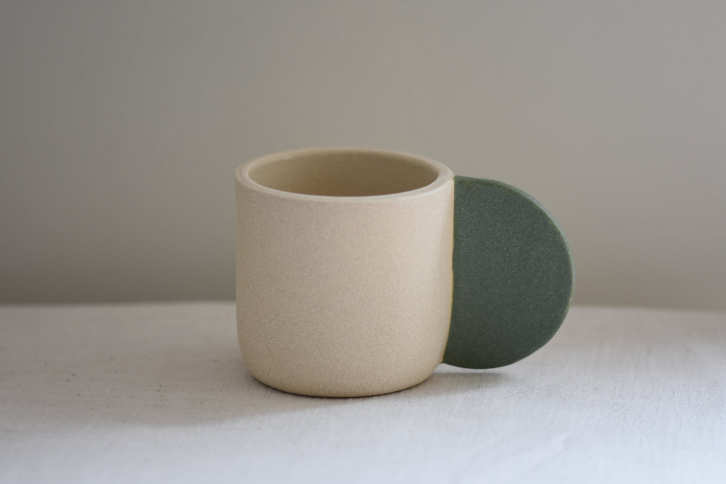 Brutes ceramics stoneware medium signature mug in textured finish with granite green glazed handle.