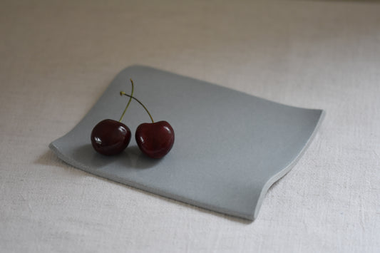 Brutes ceramics small stoneware rumpled wavy platter in pale blue with cherries.