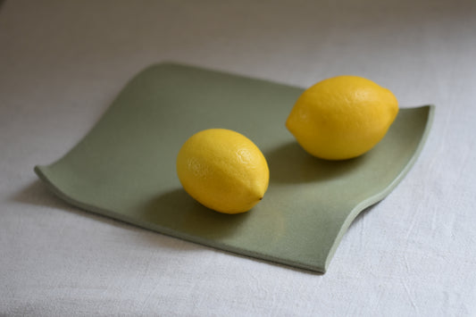 Brutes ceramics medium stoneware rumpled wavy platter in pistachio green with lemons.