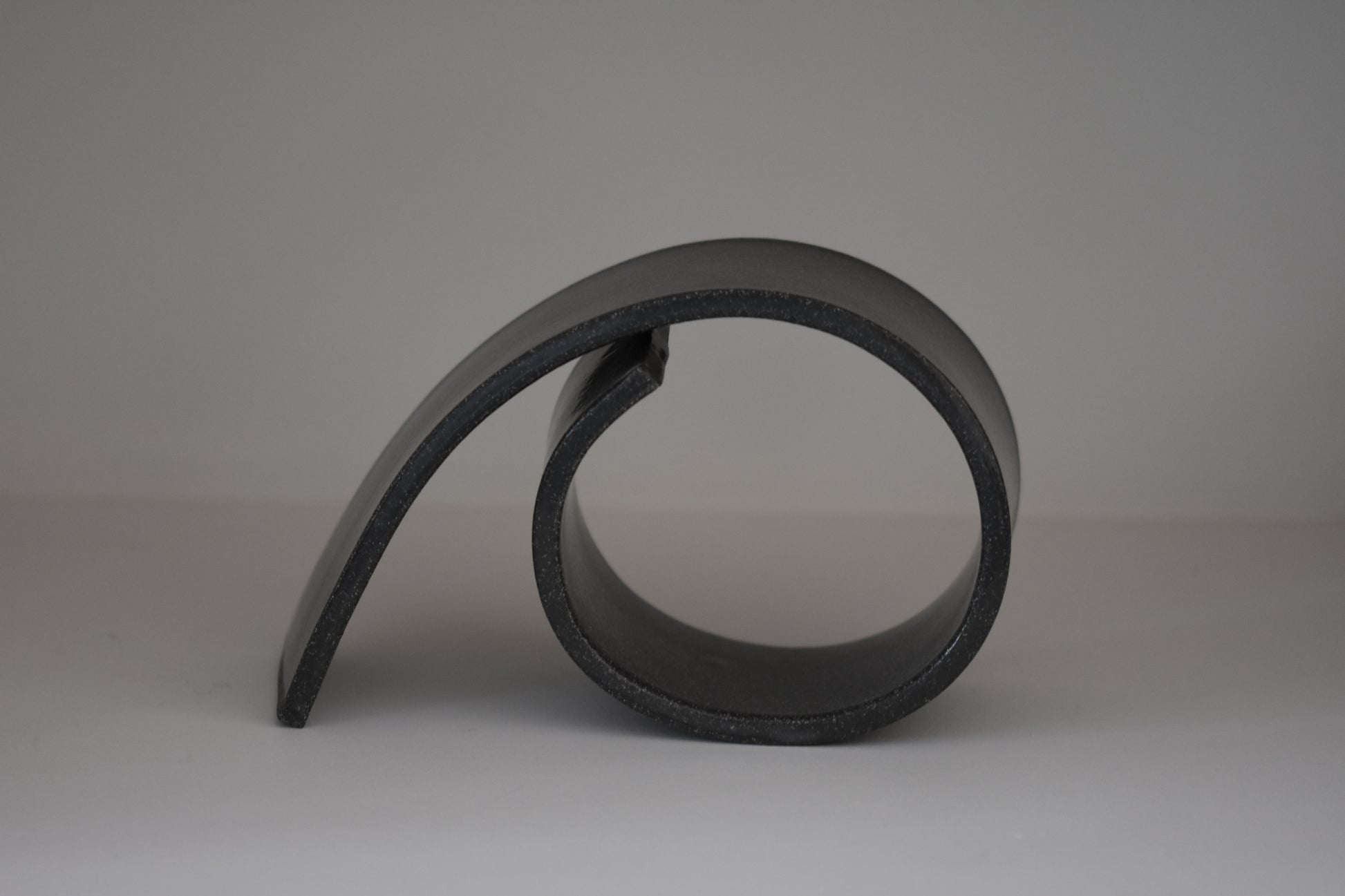 Brutes ceramics large spiral bookend in charcoal glossy stoneware.