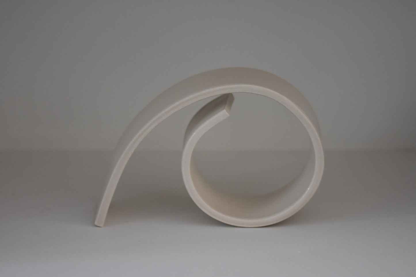 Brutes ceramics large spiral bookend in cream glossy stoneware.