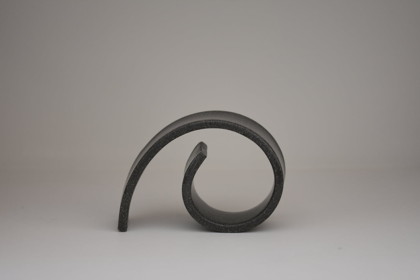 Brutes ceramics medium spiral bookend in charcoal glossy stoneware.