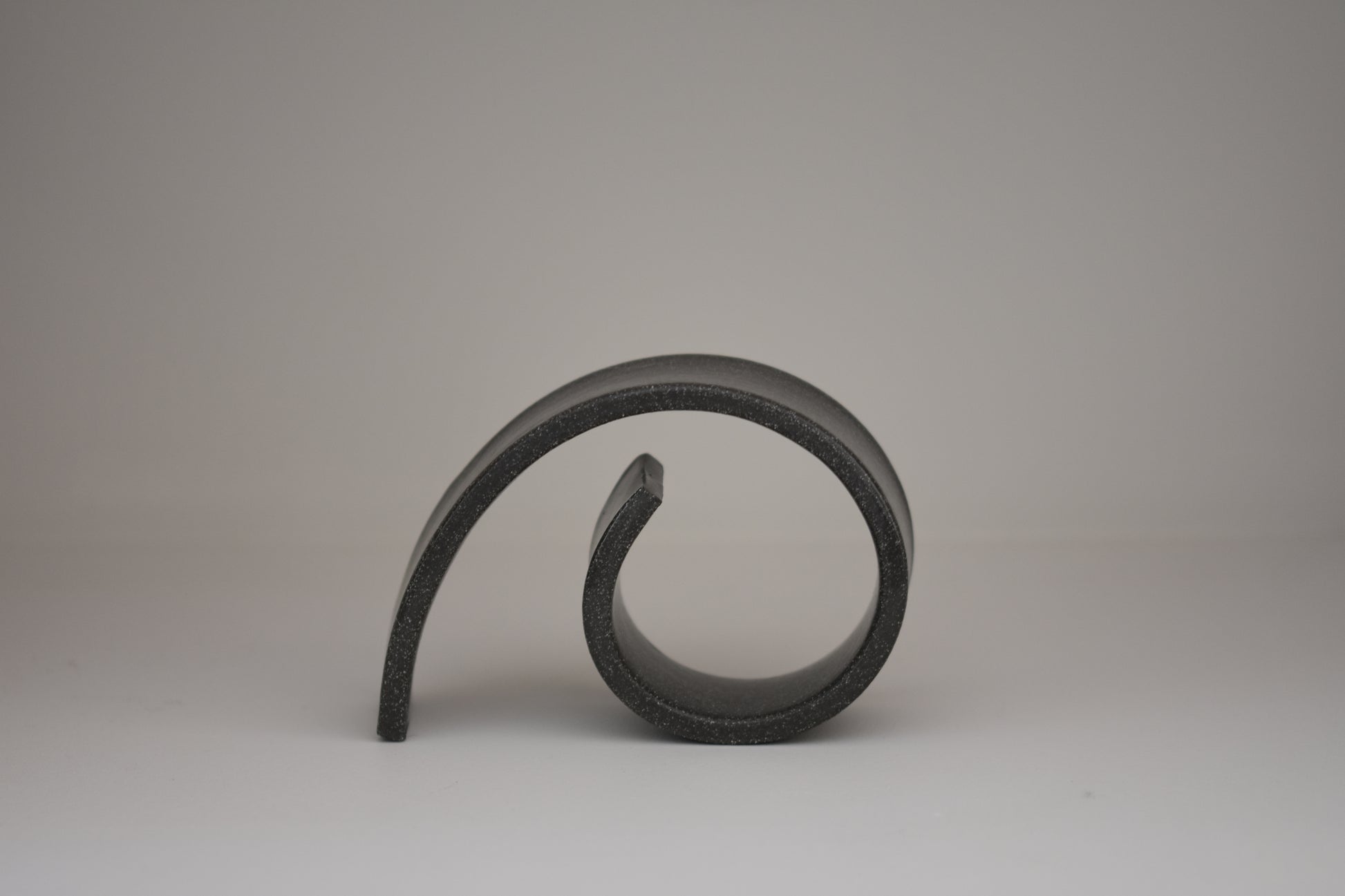 Brutes ceramics medium spiral bookend in charcoal glossy stoneware.