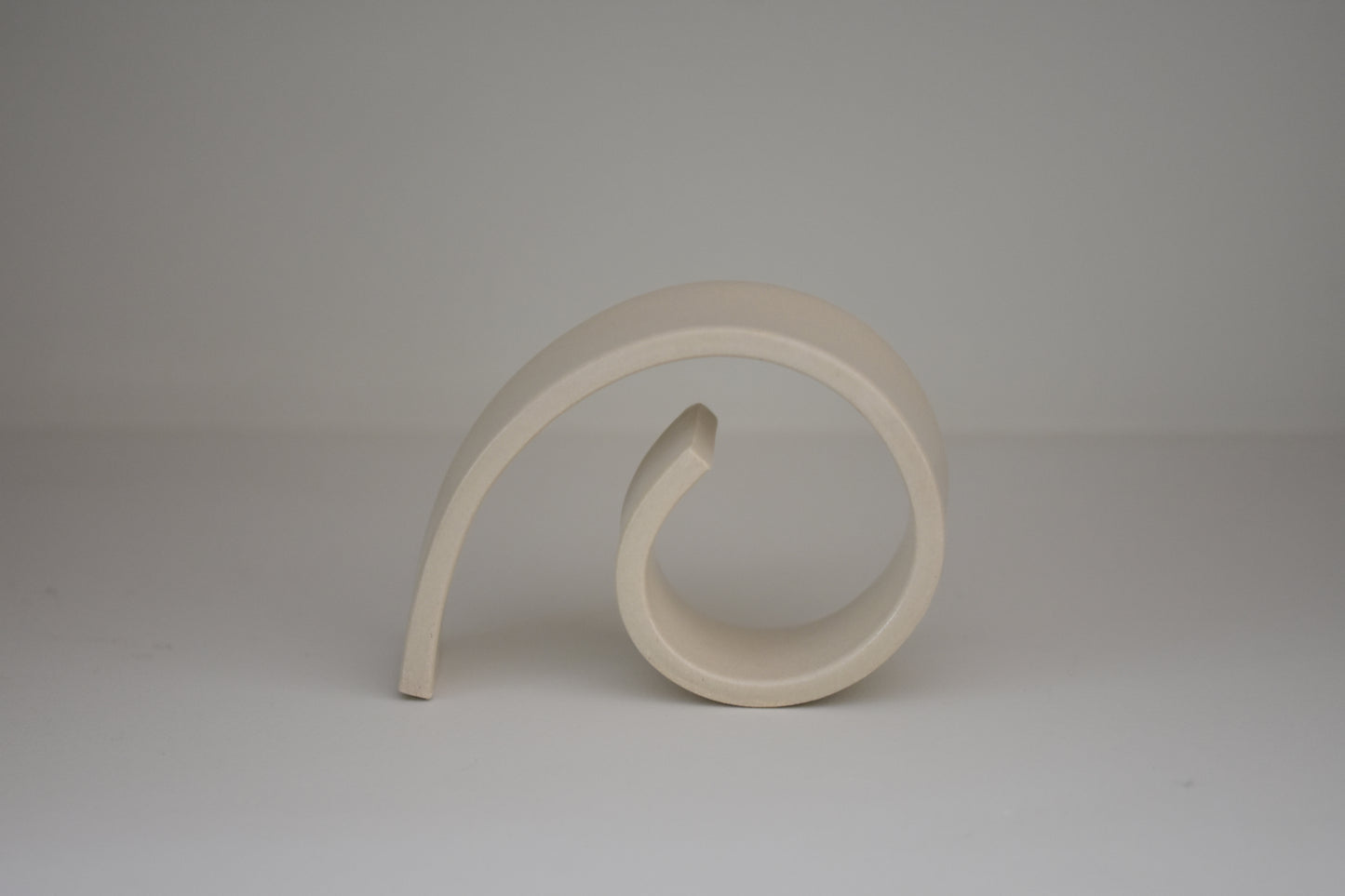 Brutes ceramics medium spiral bookend in cream glossy stoneware.