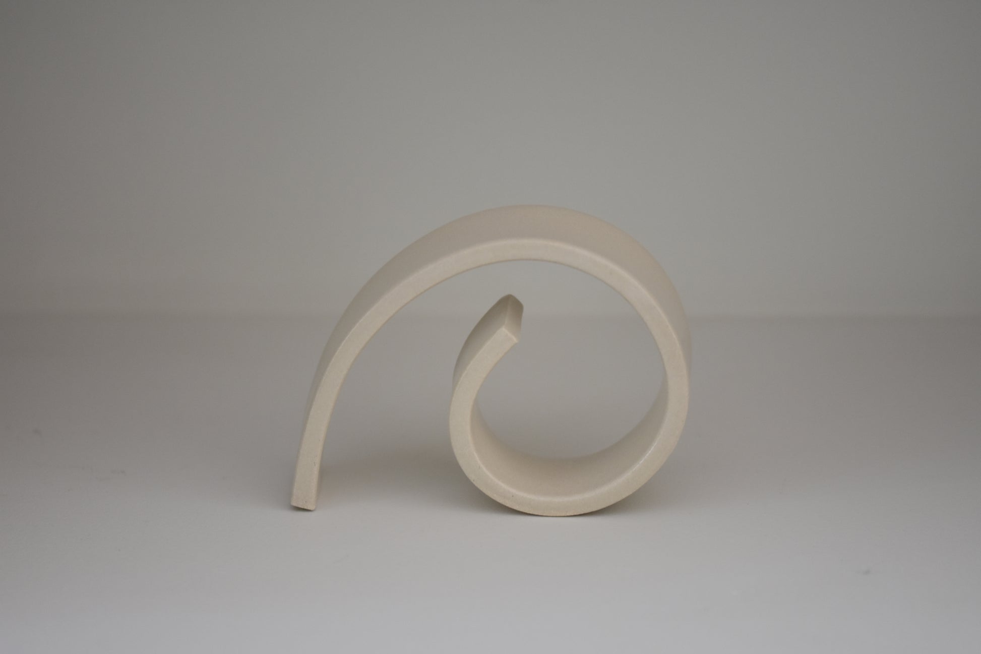 Brutes ceramics medium spiral bookend in cream glossy stoneware.