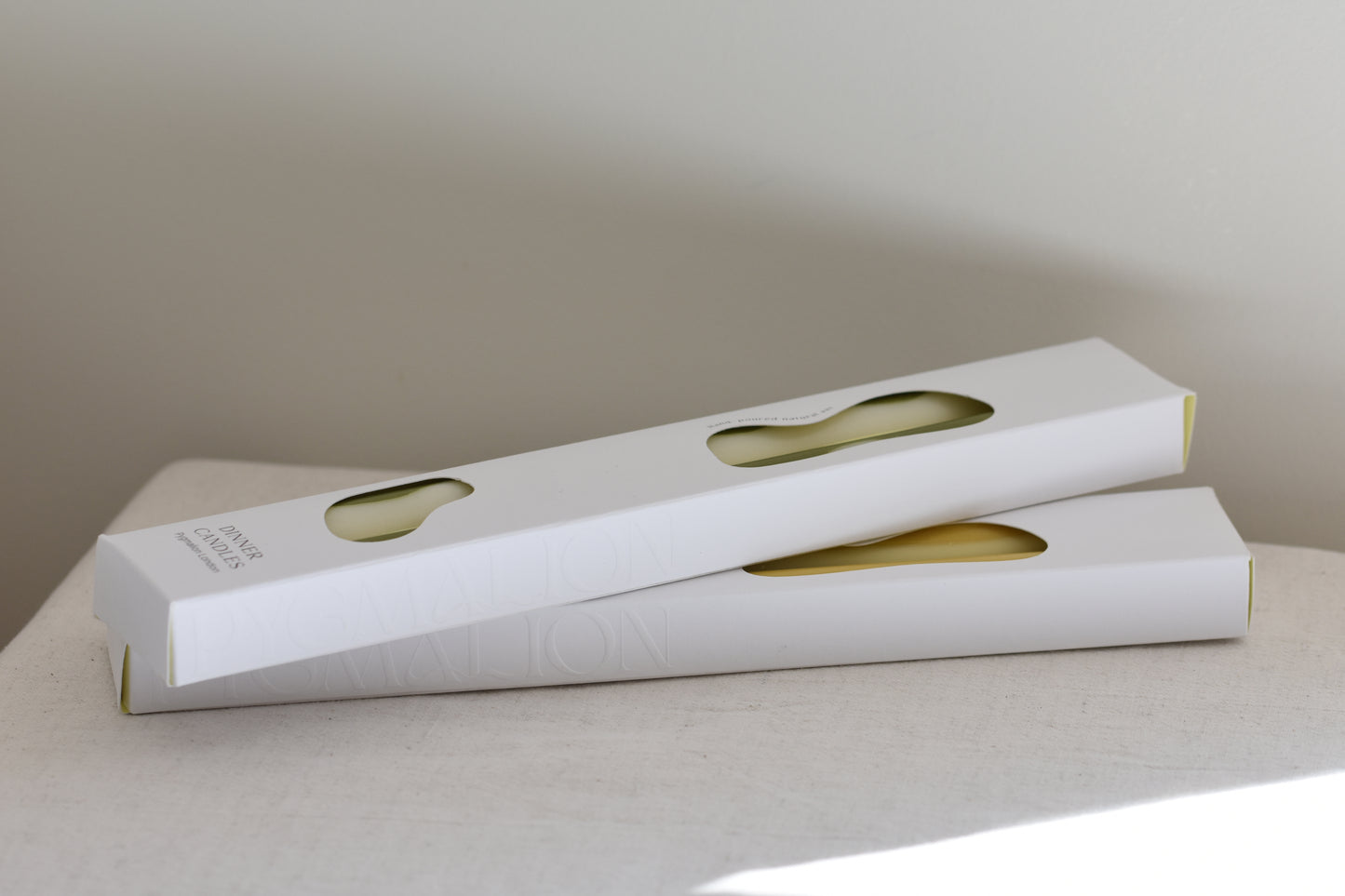 Pygmalion London dinner candle packaging, two white boxes piled on top of each other.