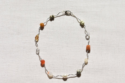 By my hands Sienna Ripple Necklace with wavy sterling silver ripples and oval clasp combined with earthy gemstones including unakite, dalmatian jasper, freshwater pearl, and coloured jade.