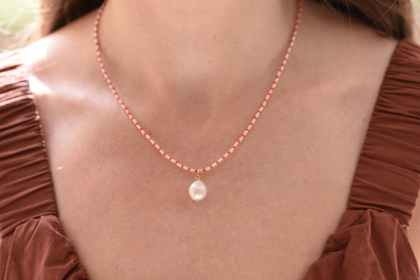 By my hands Little Baroque Necklace with stripey red and white Miyuki and Toho seed beads, small freshwater baroque pearl and gold-filled fastenings.