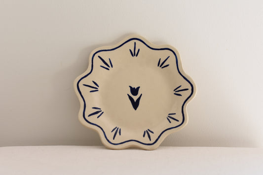 Blume Ceramics white stoneware petal shaped plate with hand painted tulip design in navy.