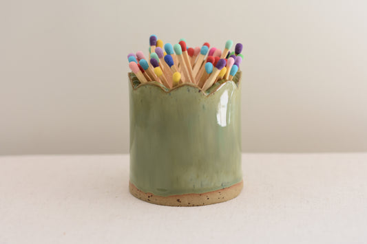 Blume Ceramics stoneware matchstick holder, glazed in green, with scalloped top and multicolour matches.