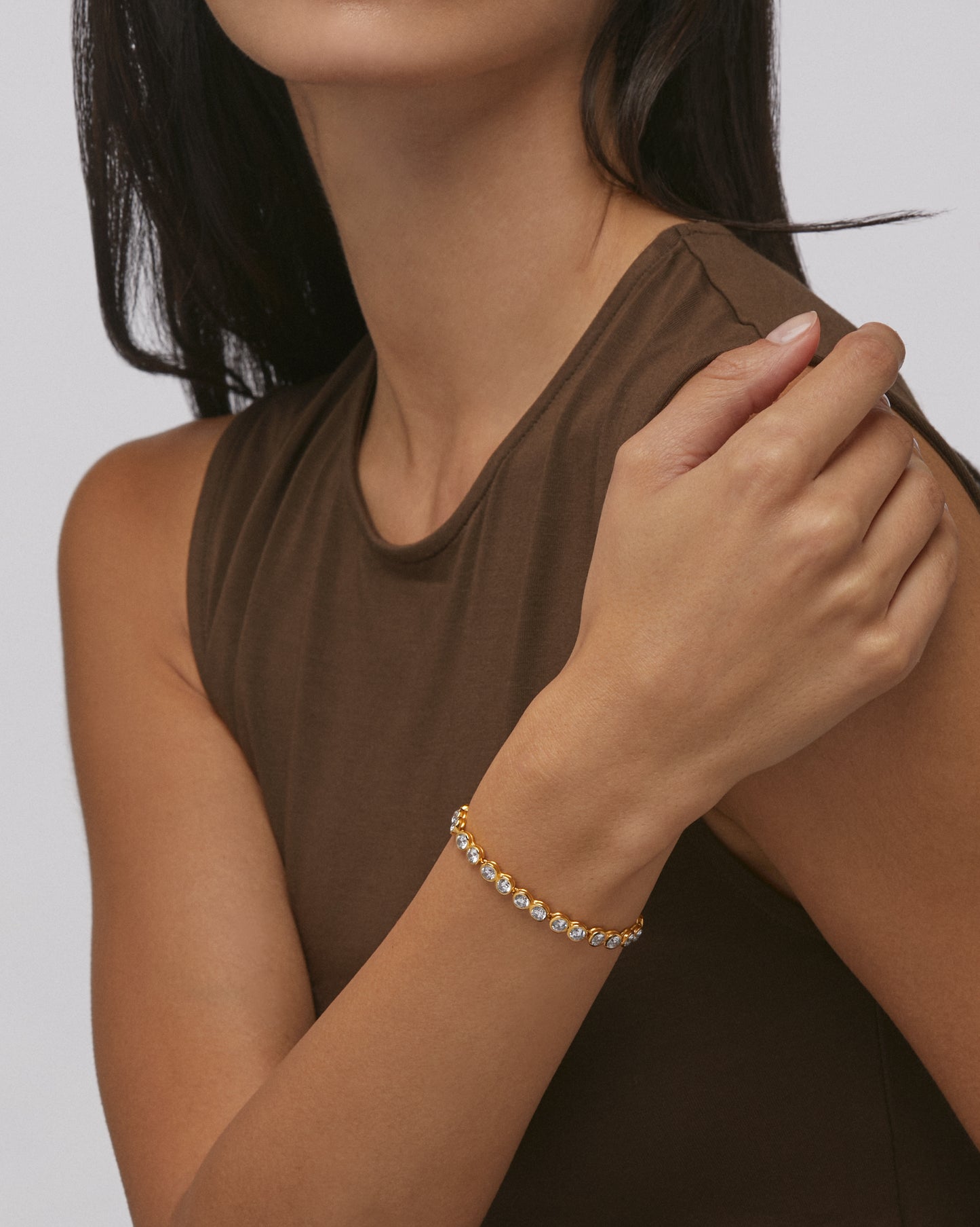 Daphine Chris gold tennis bracelet with cubic zirconia.