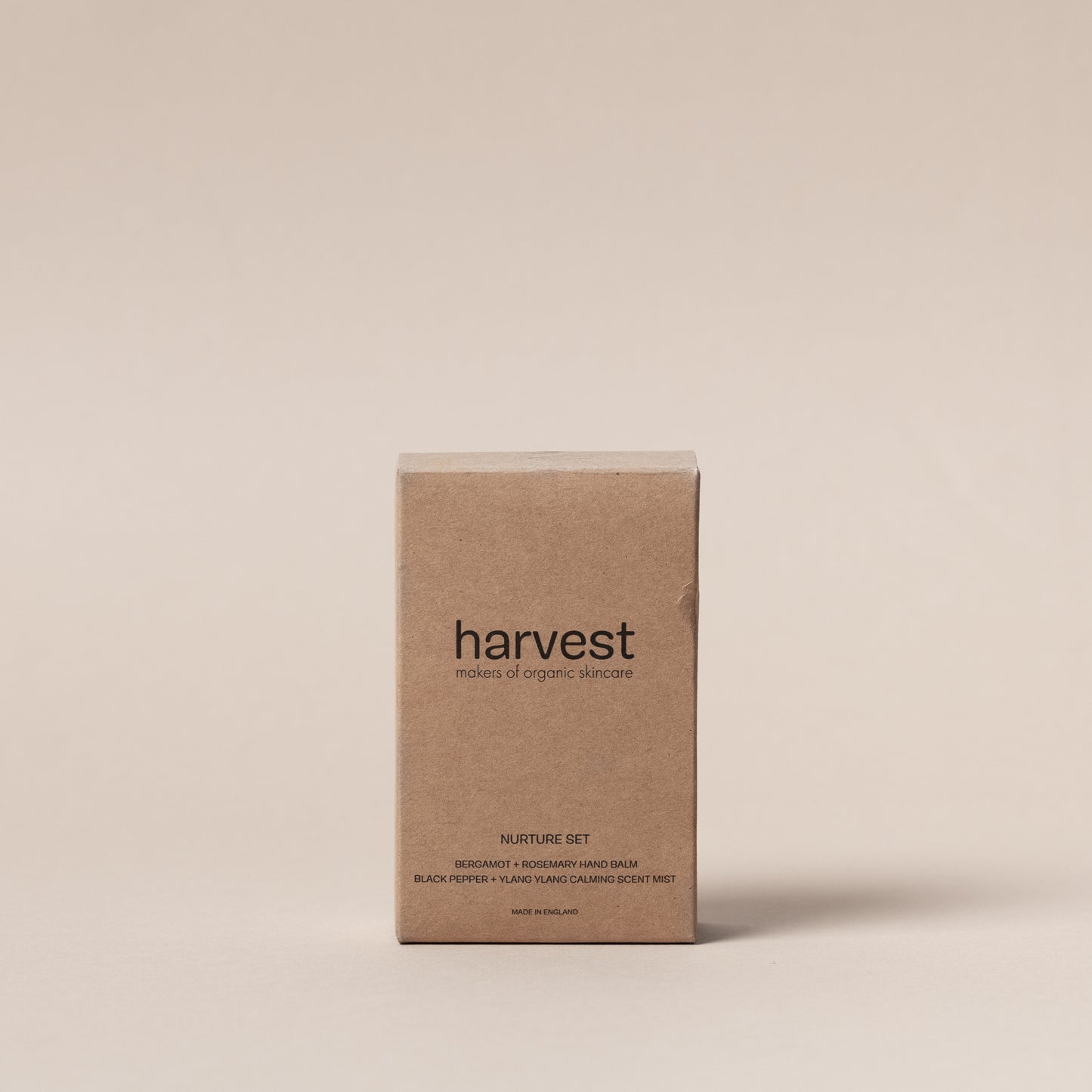 Harvest Nurture Set with Bergamot and Rosemary mini hand balm and Black Pepper and Ylang Ylang calming mist in brown glass bottles and brown box.