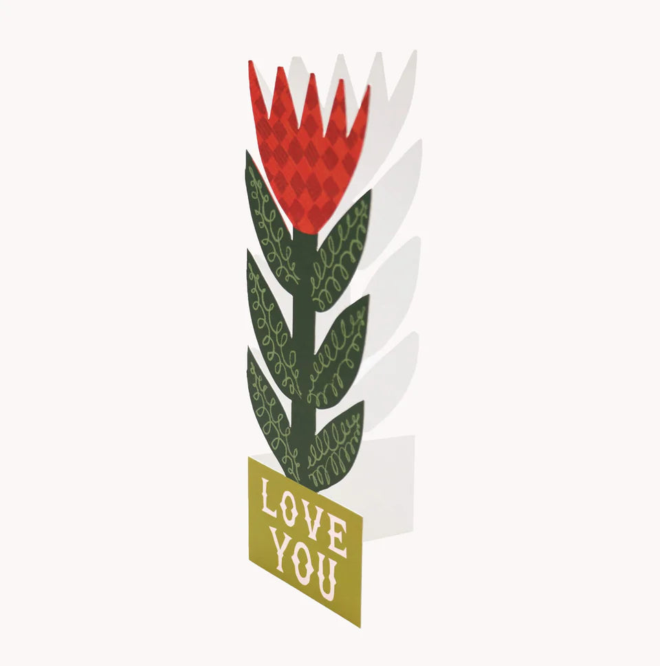 Hadley Paper Goods Checkerboard lily card featuring a stand up red and green flower side view, on a white background.