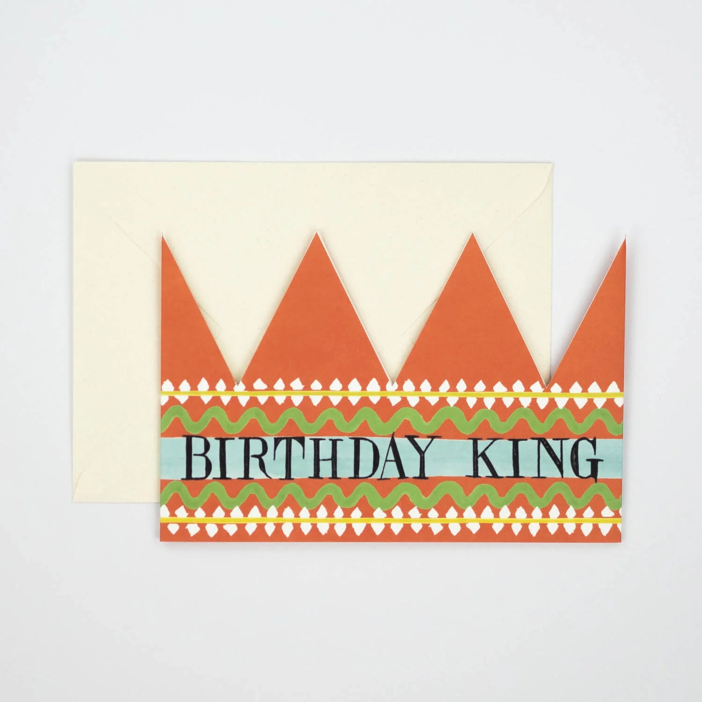 Hadley Paper Goods Birthday King party hat crown shaped card with orange, green and blue pattern, and an ivory envelope on a white background.