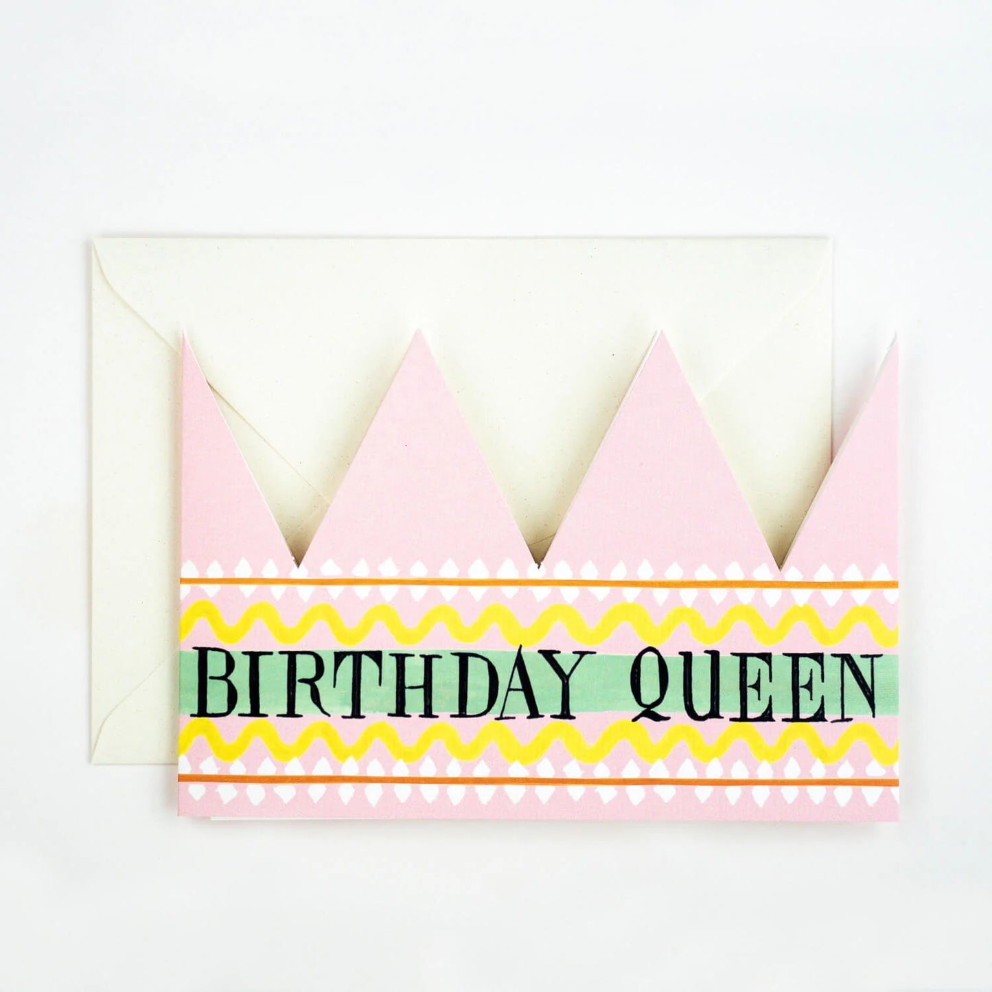 Hadley Paper Goods Birthday Queen party hat crown shaped card with pink, green and yellow pattern, and ivory envelope, on a white background.