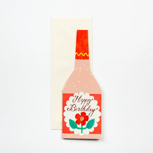 Hadley Paper Goods rose bottle shaped Happy Birthday card with flower design in pink, red and green, with ivory envelope on a white background.