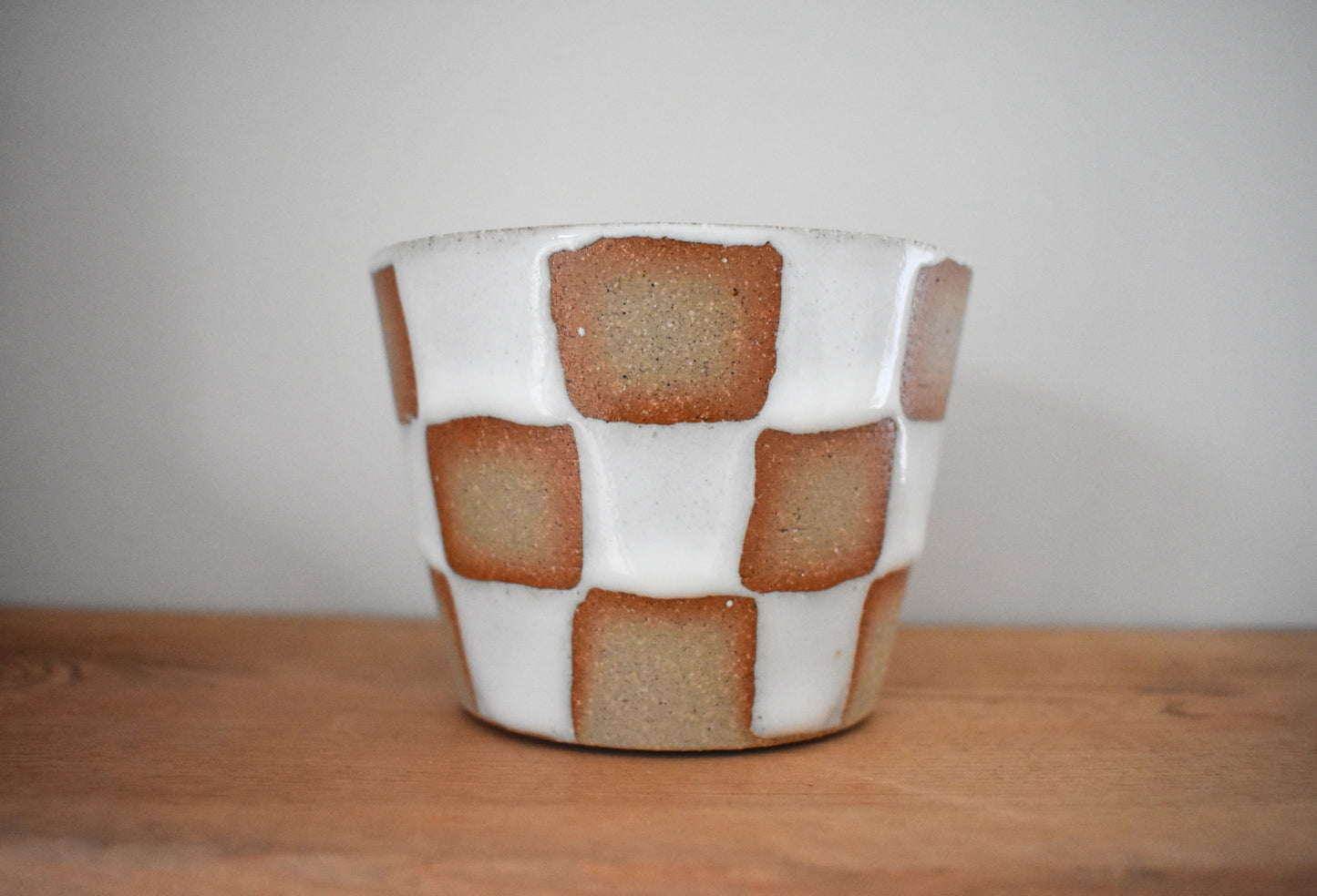 AEA Studio ceramic stoneware cup with white chequer pattern.