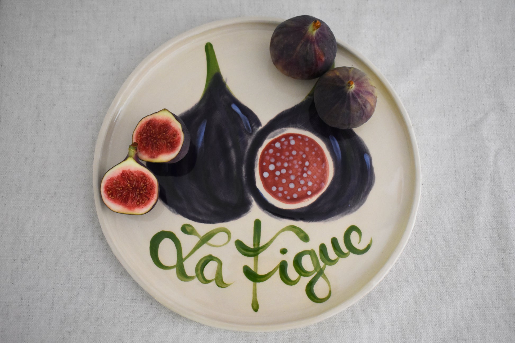 Harlie Brown earthenware ceramic La Figue plate with painted fig design and french writing.