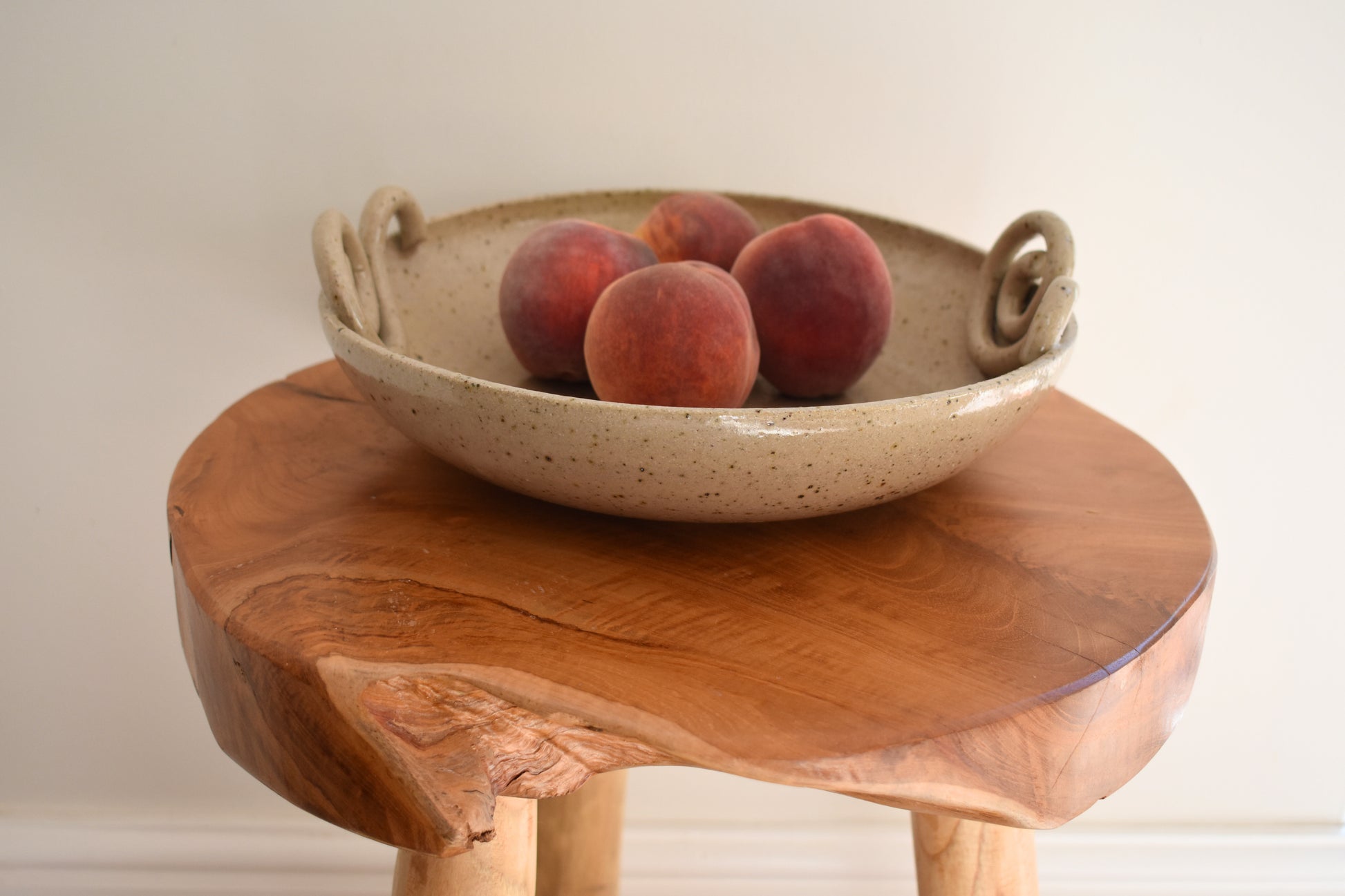 We Are Clay Snail fruit bowl in beige flecked ceramic with spiral design.