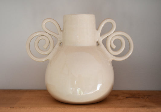 We Are Clay Pretzel Vase in white ceramic with spiral handles.