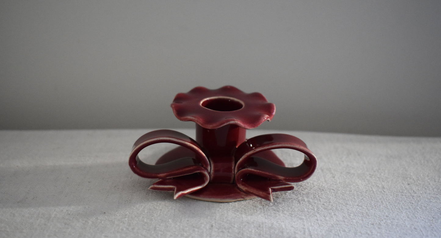 Superfluities stoneware ceramic Bow Candlestick with frill in burgundy.