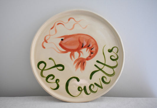 Harlie Brown earthenware ceramic Les Crevettes plate with painted prawn design and french writing.