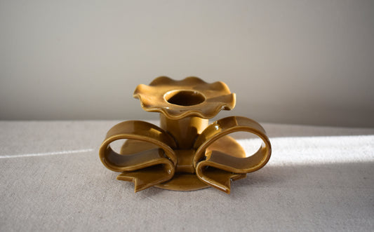 Superfluities stoneware ceramic Bow Candlestick with frill in honey ochre yellow.