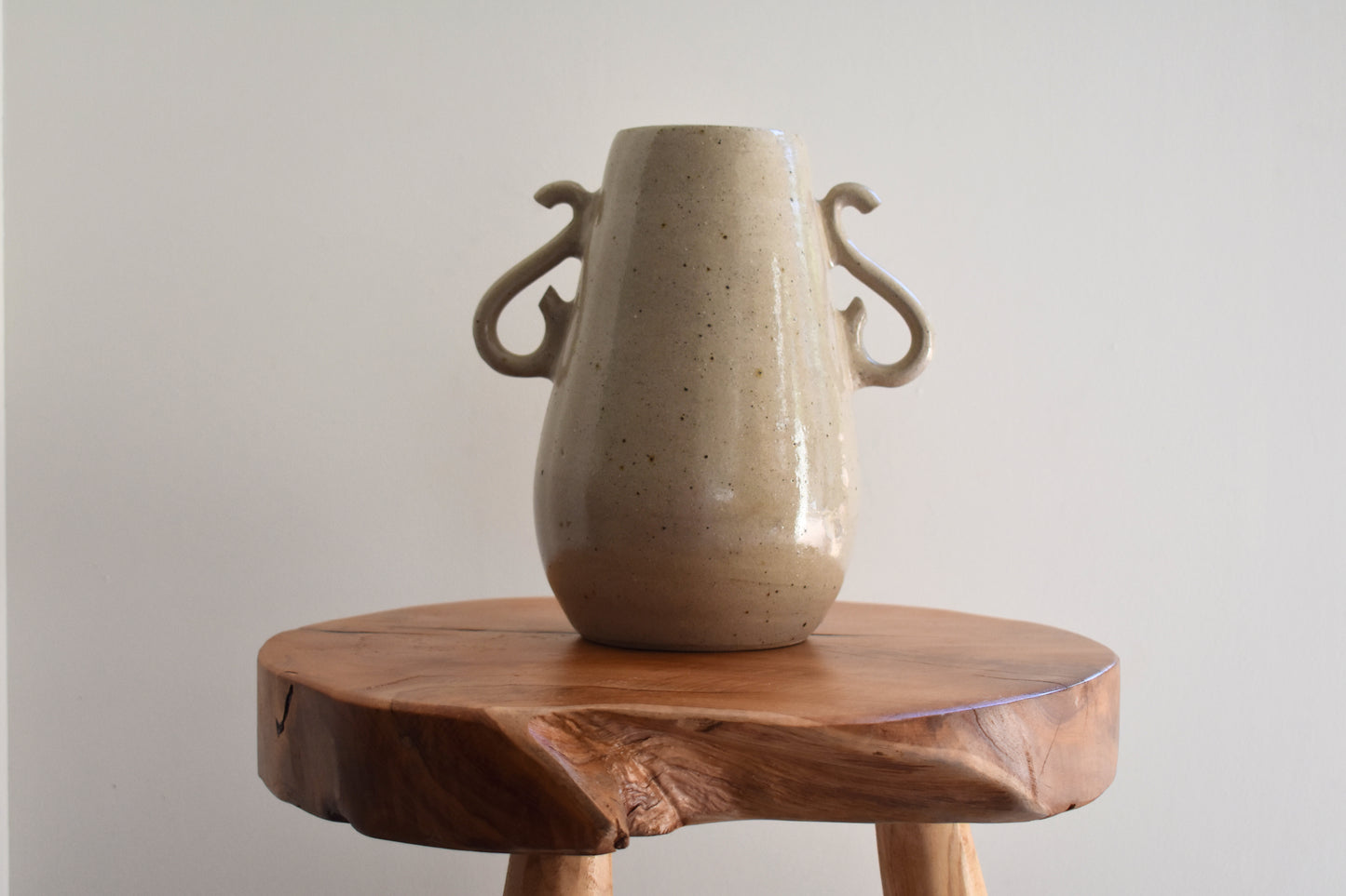 We Are Clay Curly Vase in flecked beige ceramic with curly handles.