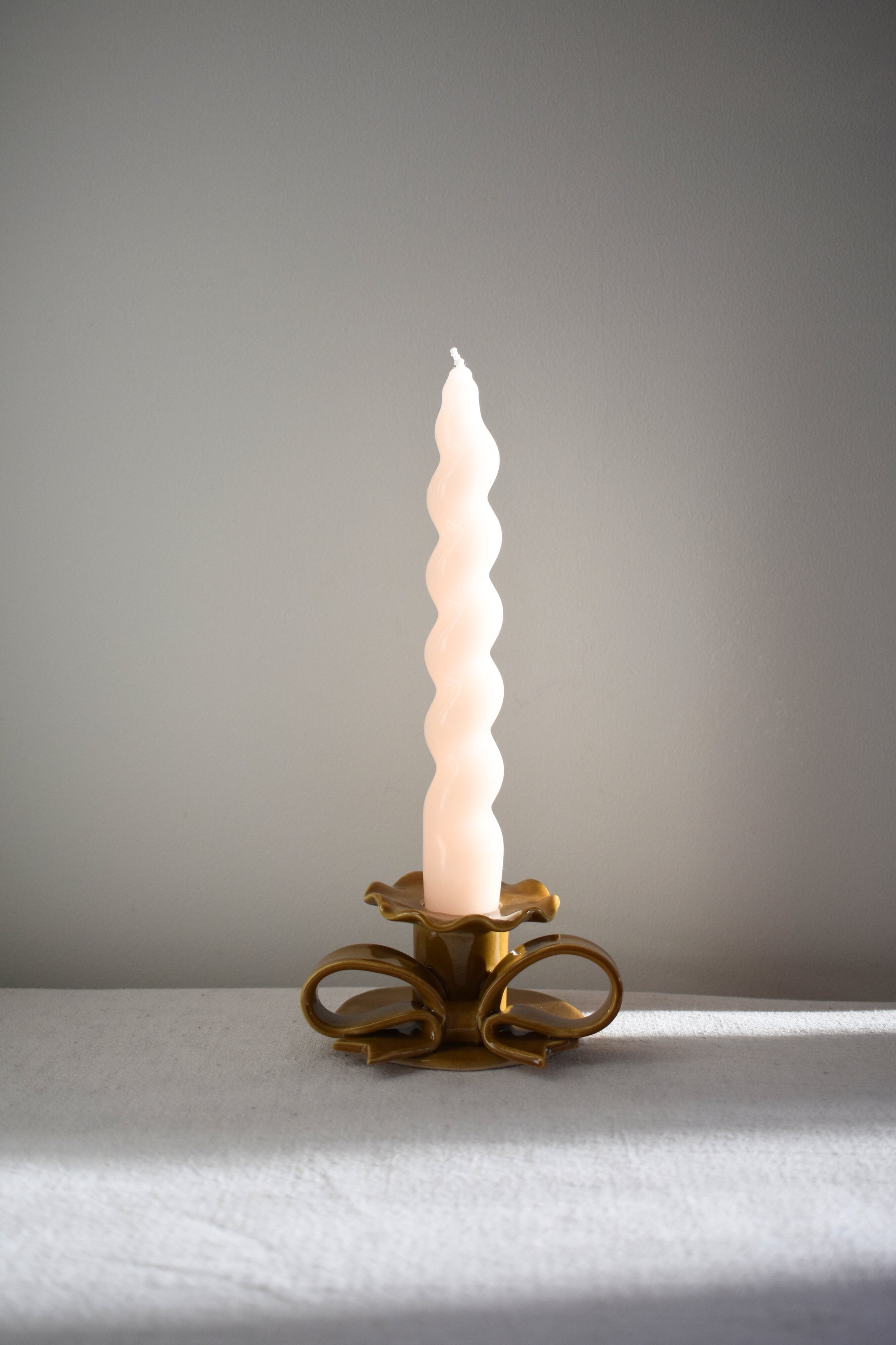 Superfluities stoneware ceramic Bow Candlestick with frill in honey ochre yellow.