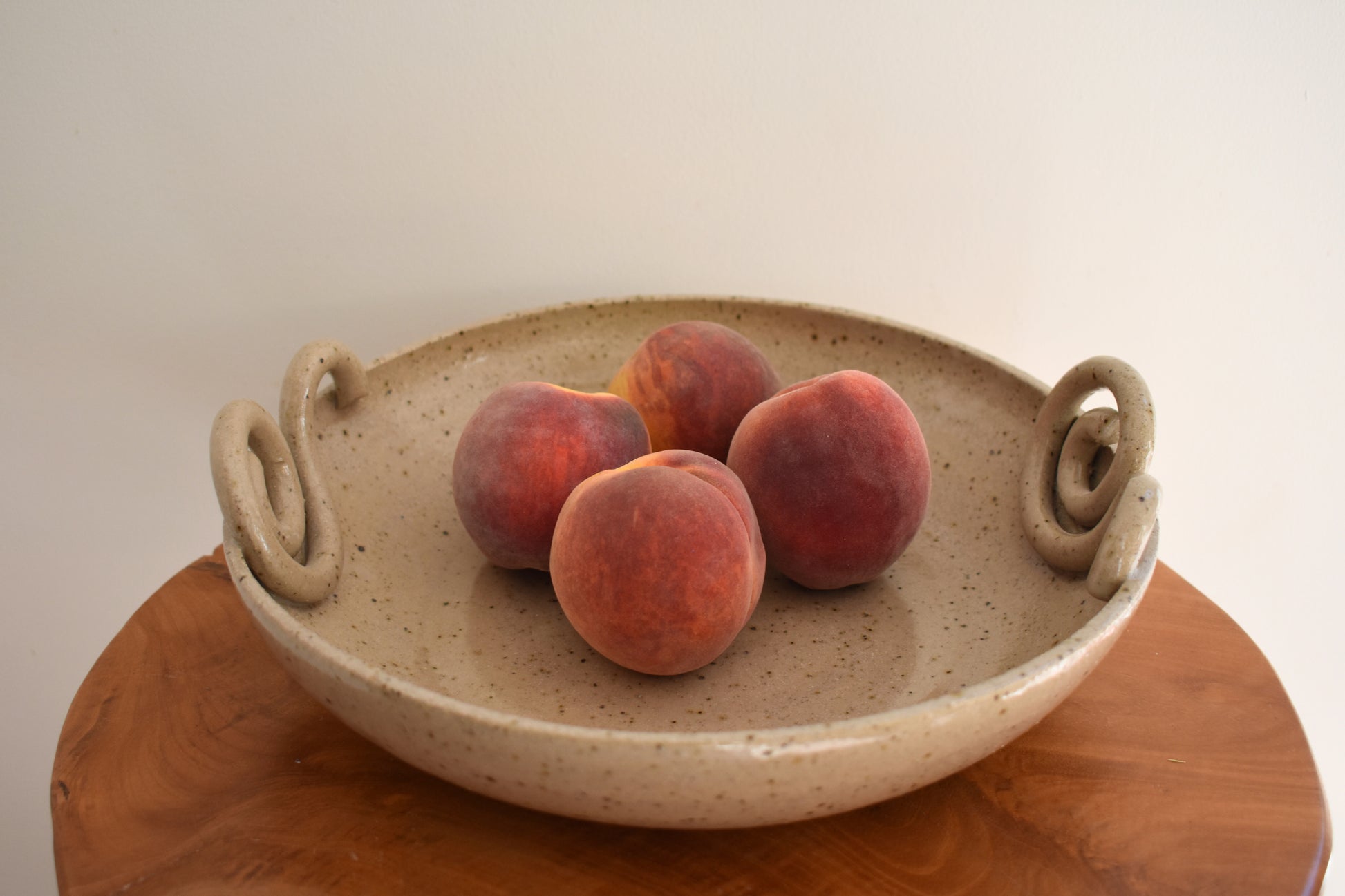 We Are Clay Snail fruit bowl in beige flecked ceramic with spiral design.