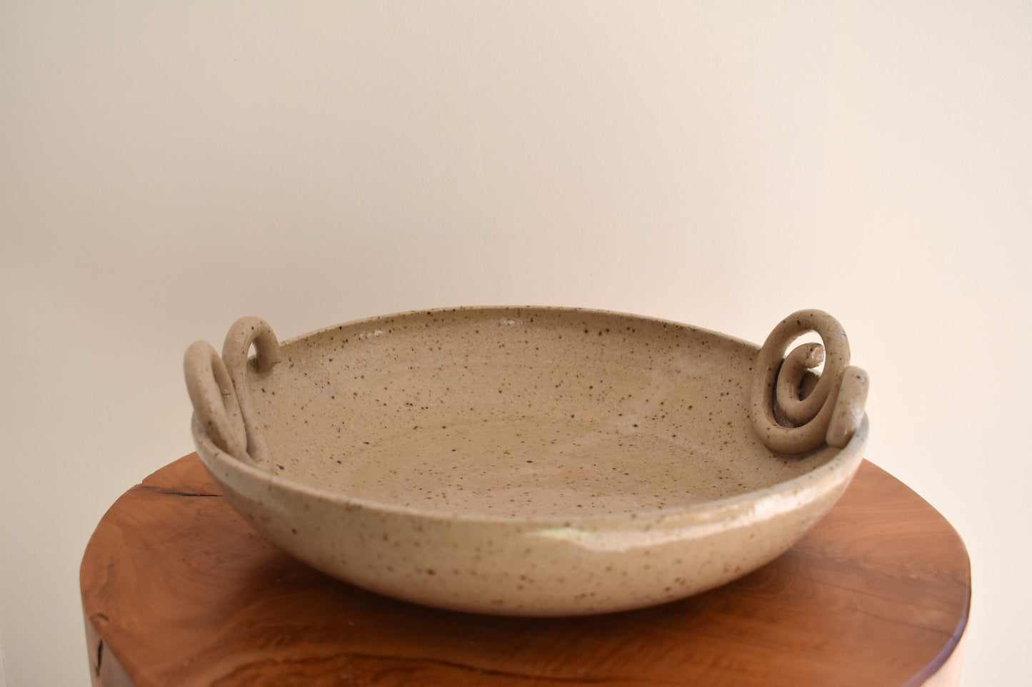 We Are Clay Snail fruit bowl in beige flecked ceramic with spiral design.