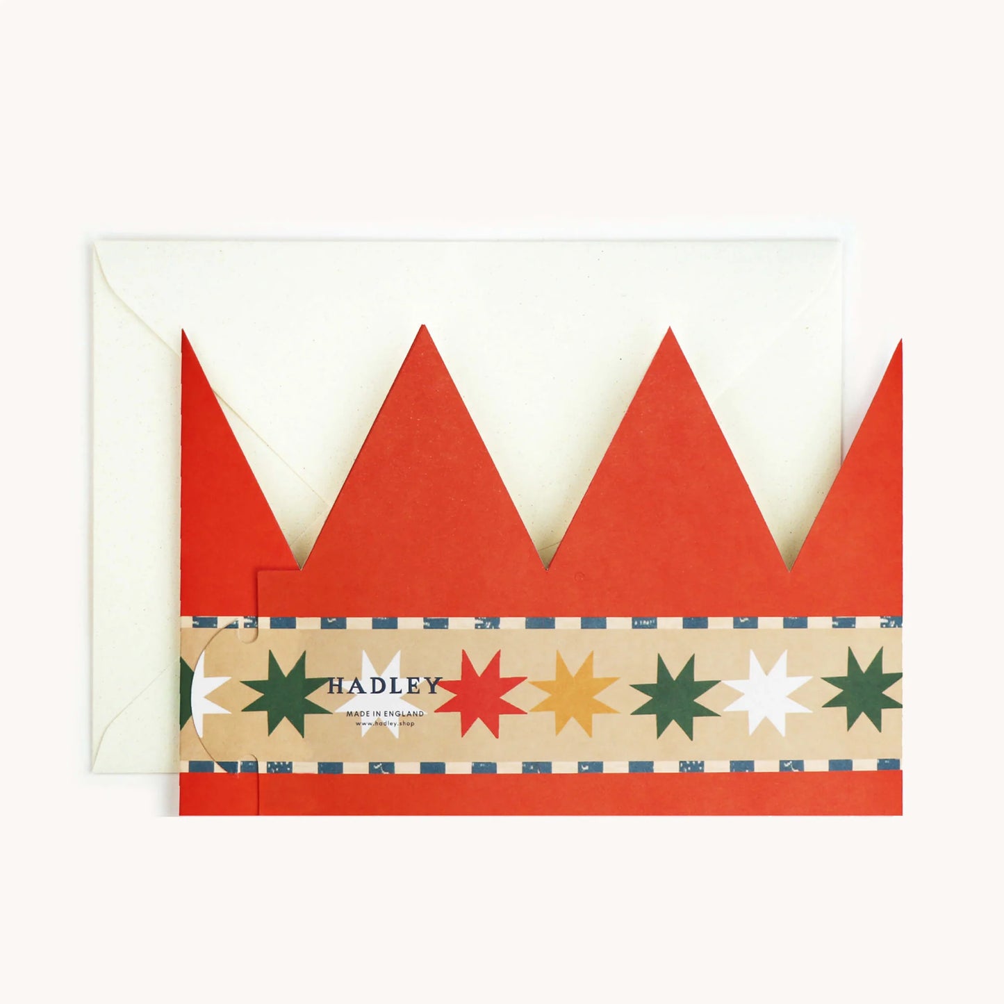 Hadley Paper Goods Chief Elf party hat crown shaped card in orange with blue pattern and multicoloured stars, back view, on a white background.