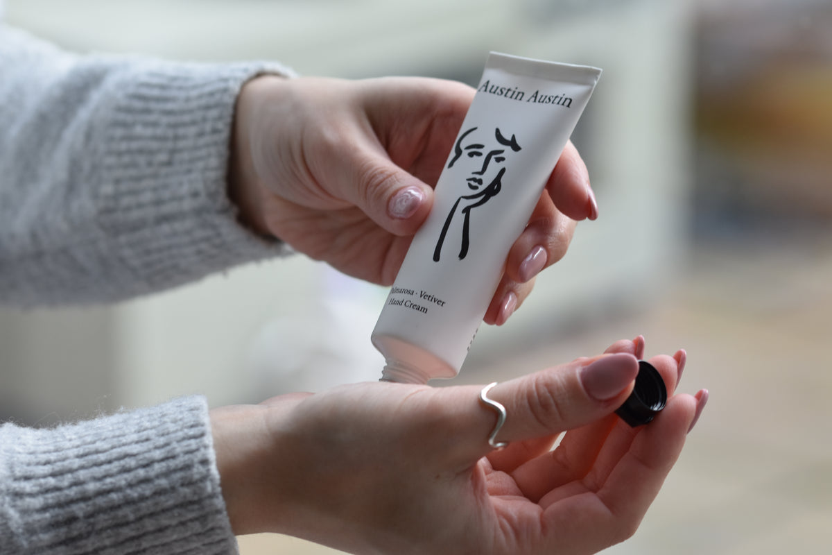 Austin Austin Organic Palmarosa & Vetiver hand cream tube with face outline artwork by Christian Newby.