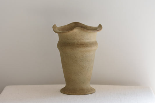 Vintage Hillstonia beige stoneware vase with wavy rim on a beige background.