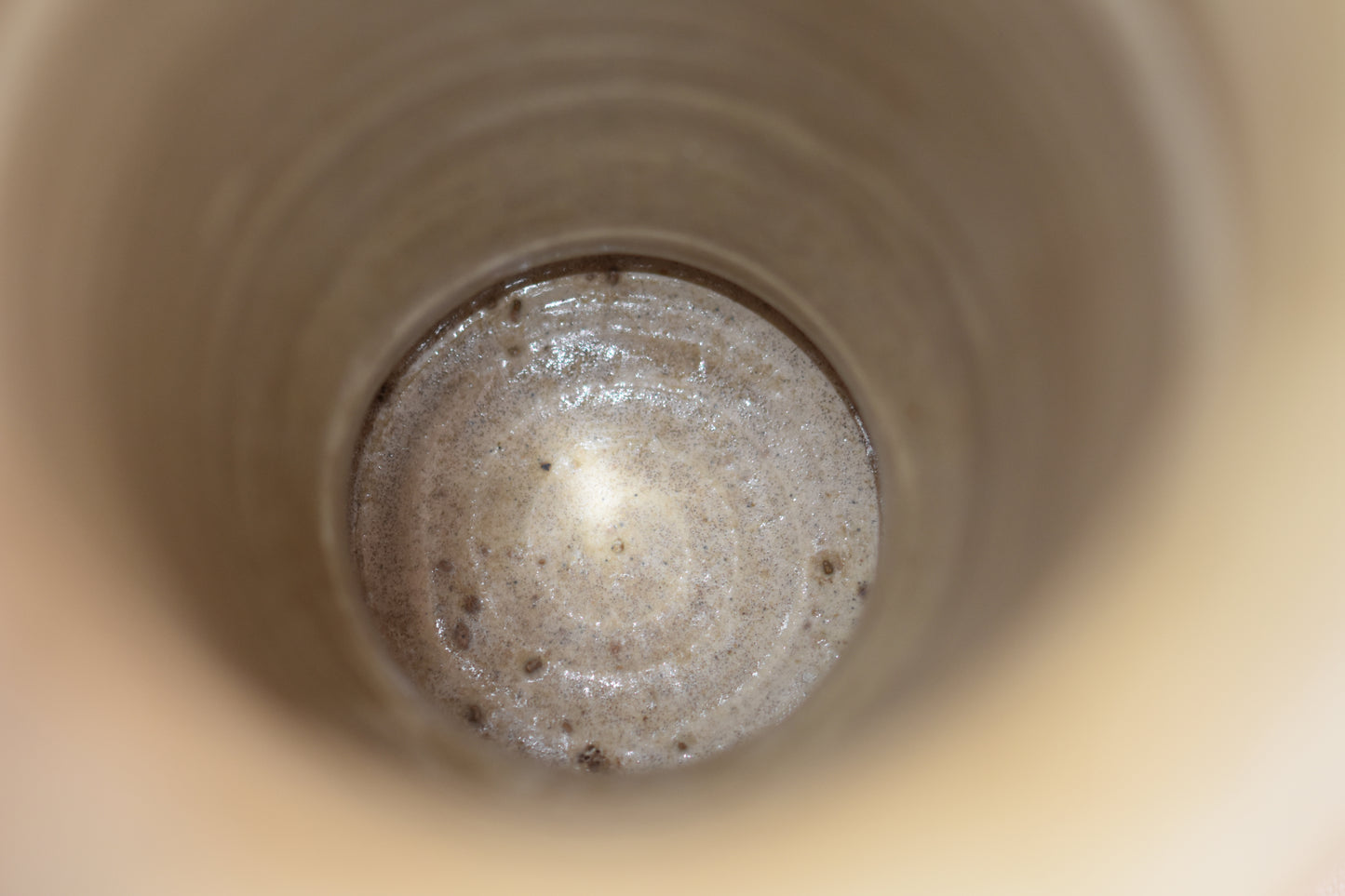 Close up of inside of a vintage Hillstonia beige stoneware vase.
