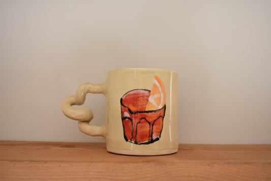 Harlie Brown white earthenware Negroni Wiggle Mug with painted negroni design and writing, and curly handle.