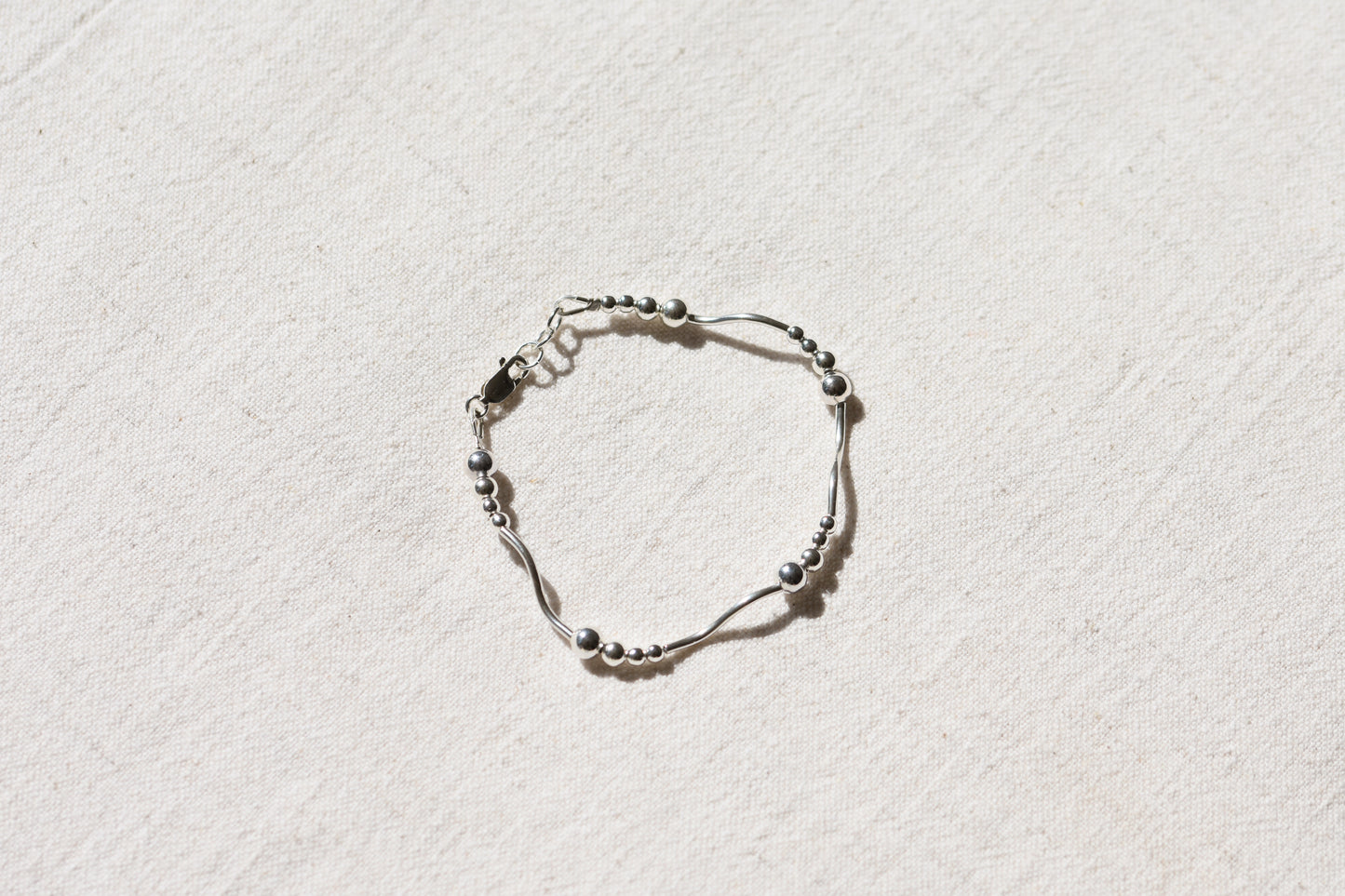 By my hands Ripple Bracelet with sterling silver wavy ripples, beads and fastening.