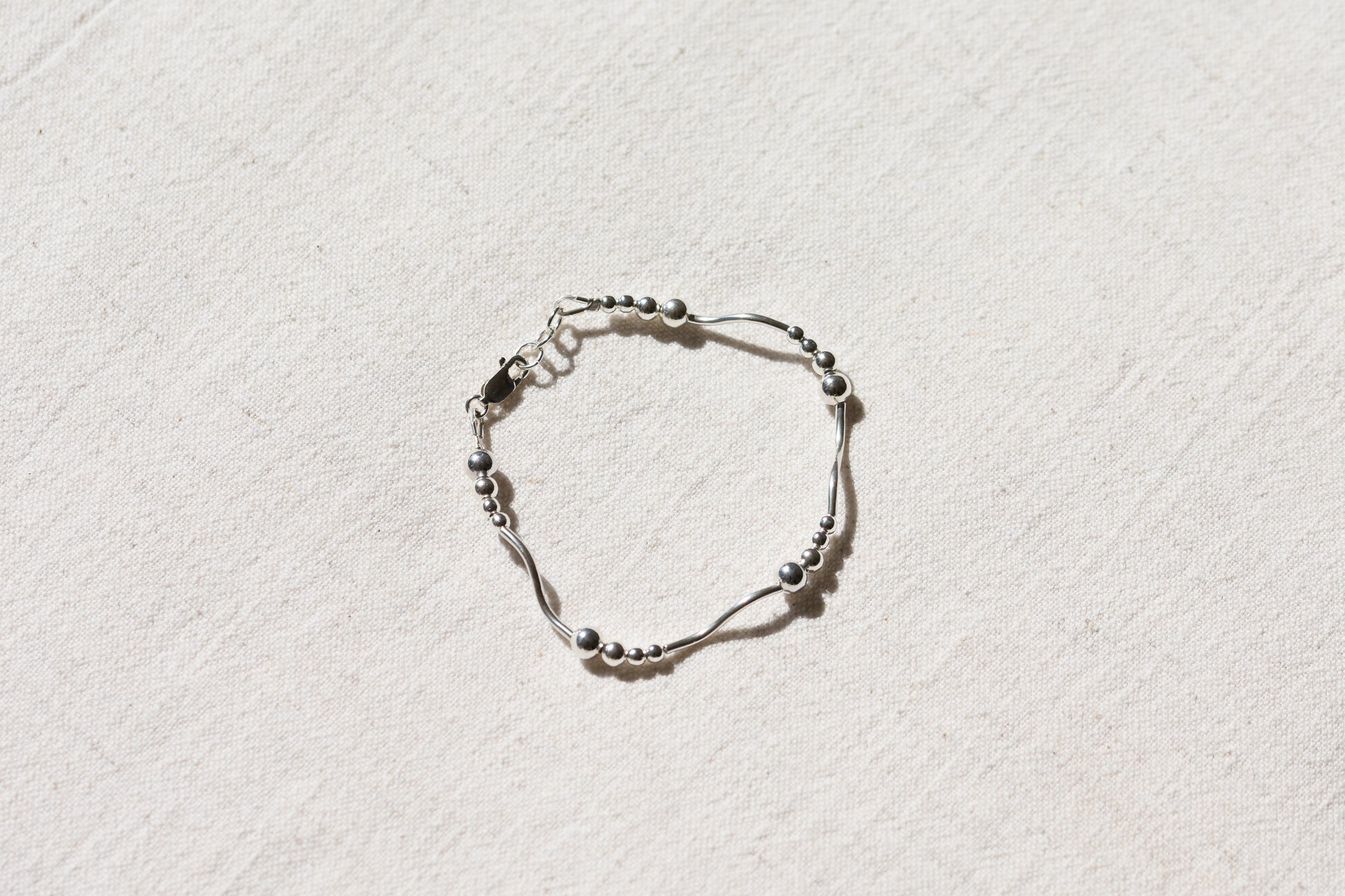 By my hands Ripple Bracelet with sterling silver wavy ripples, beads and fastening.