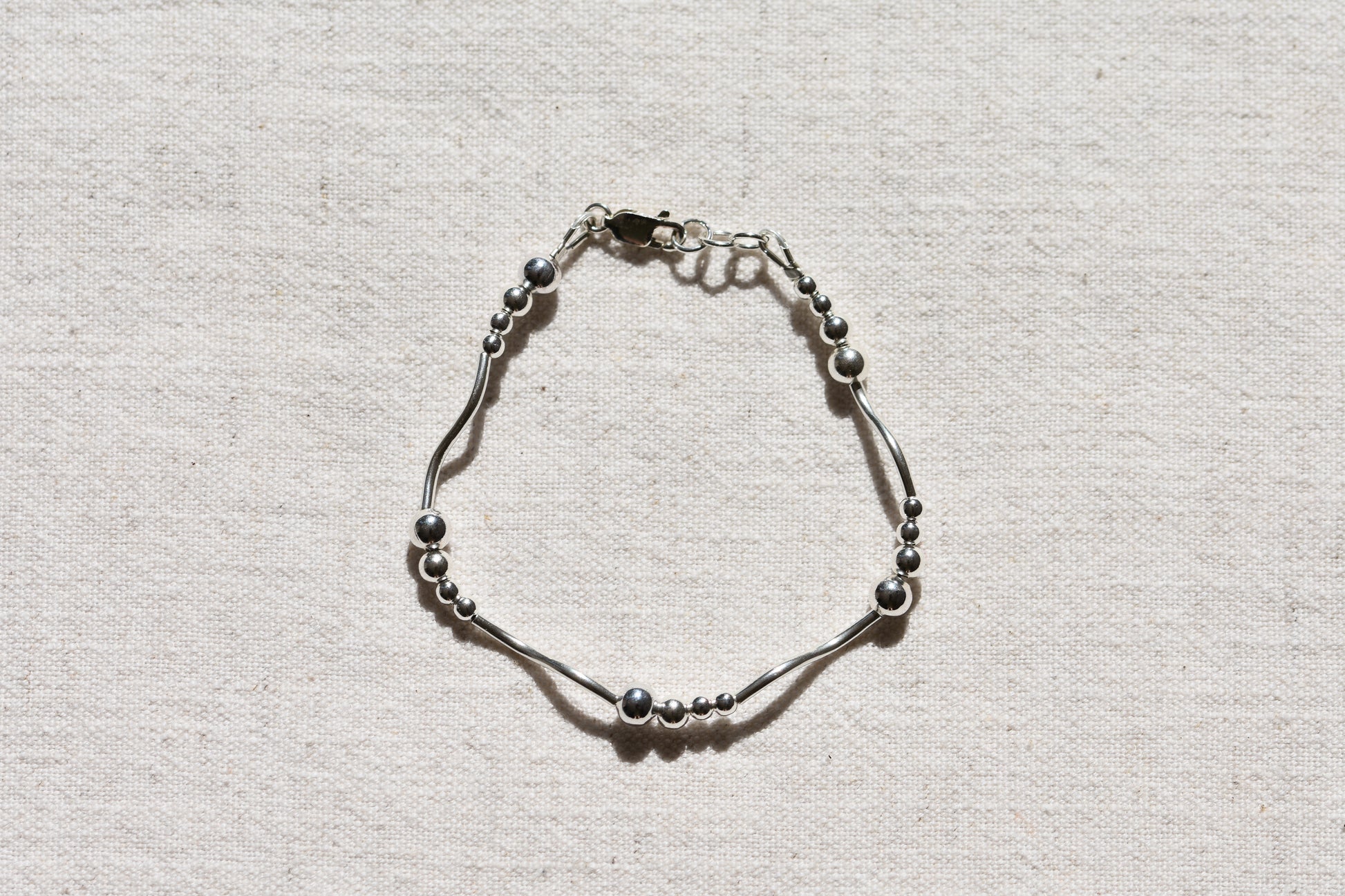 By my hands Ripple Bracelet with sterling silver wavy ripples, beads and fastening.