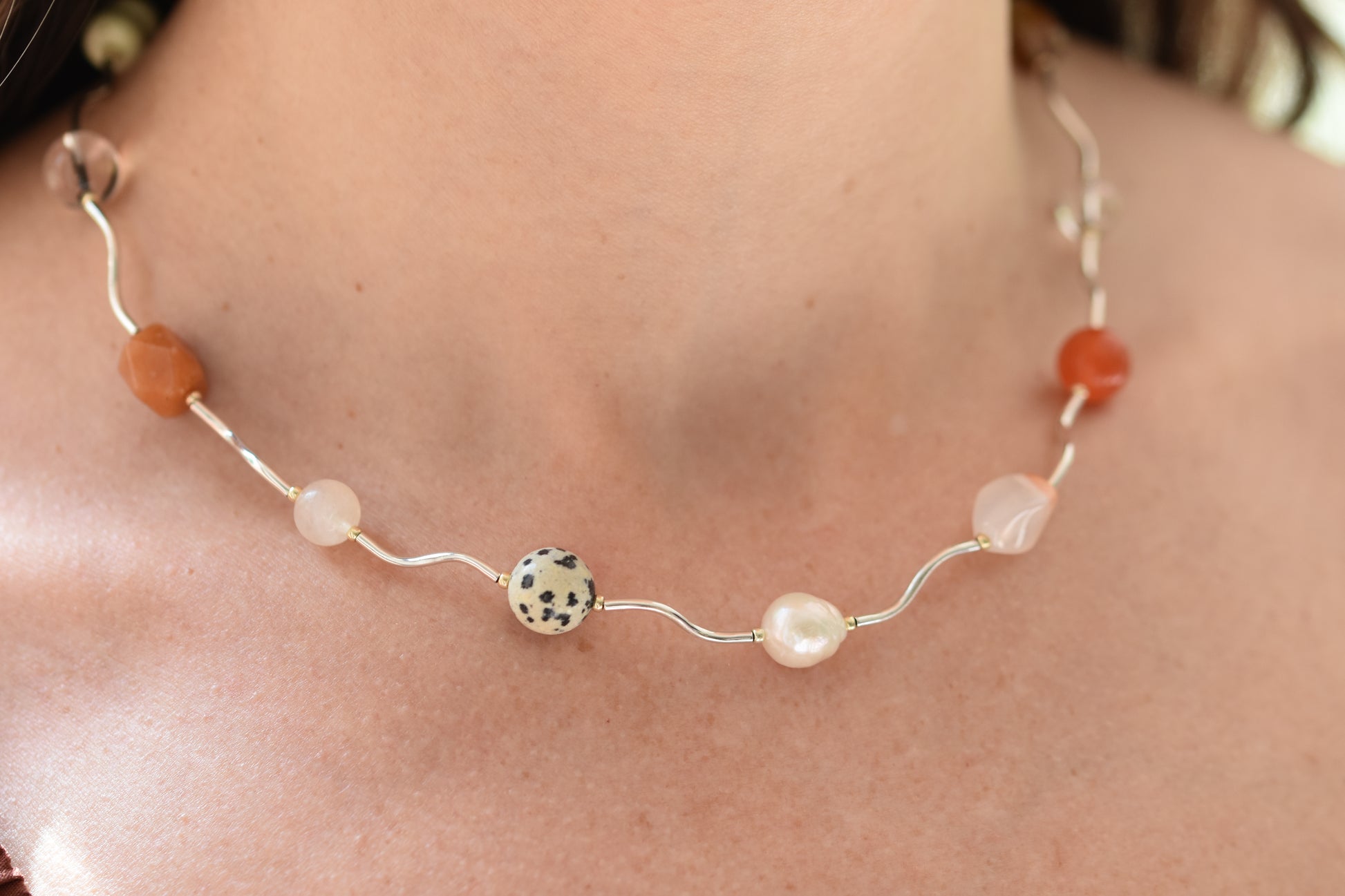By my hands Sienna Ripple Necklace with wavy sterling silver ripples and oval clasp combined with earthy gemstones including unakite, dalmatian jasper, freshwater pearl, and coloured jade. 