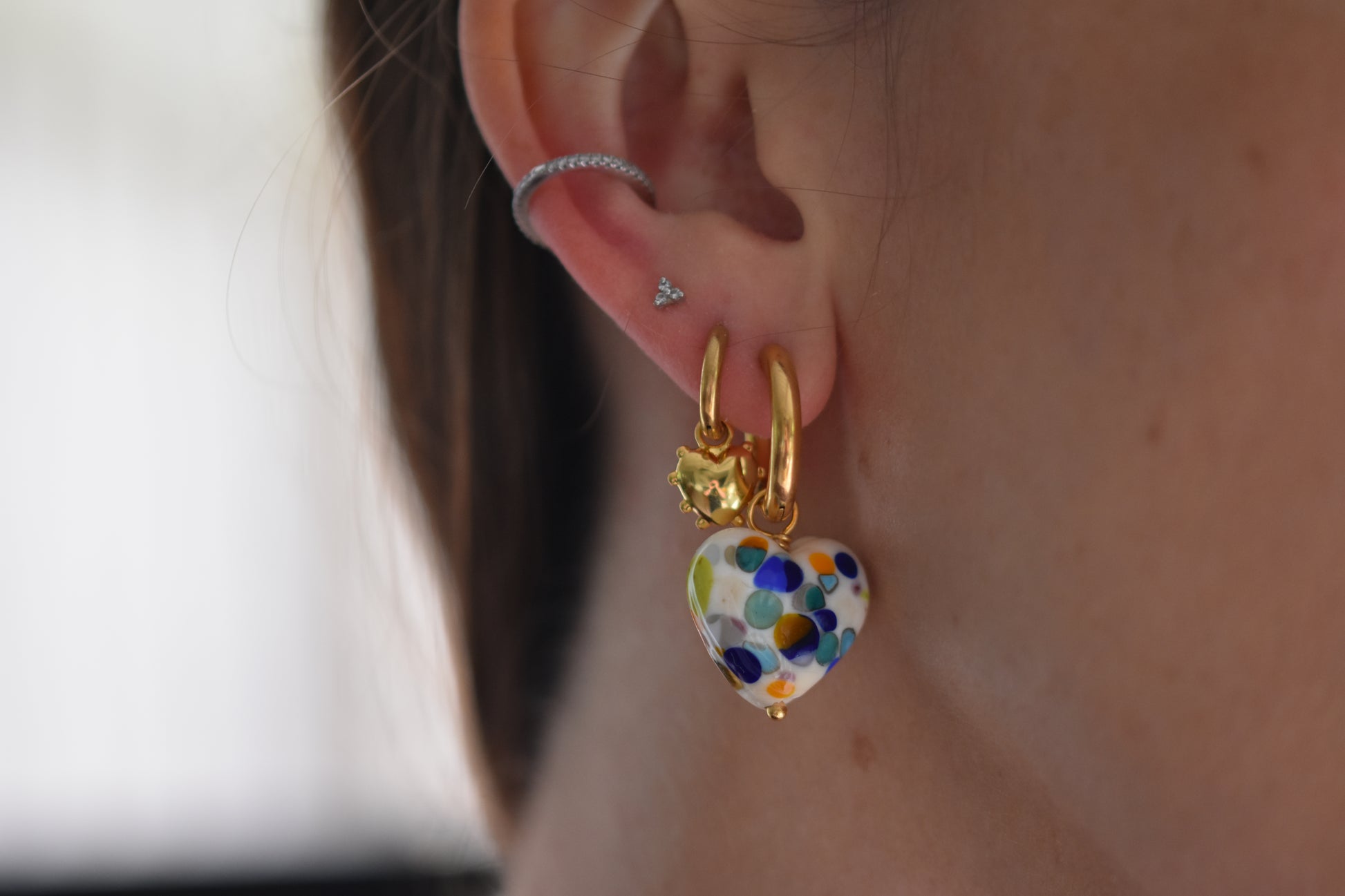 Sandralexandra Zero Waste multicolour glass heart earring with gold hoops and Mini Milagros heart hoop earring in gold.