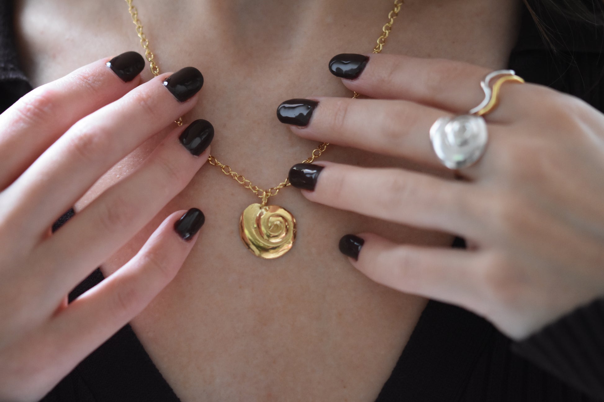 Hannah Bourn Periwinkle necklace with spiral swirl shell pendant on a chain in gold.