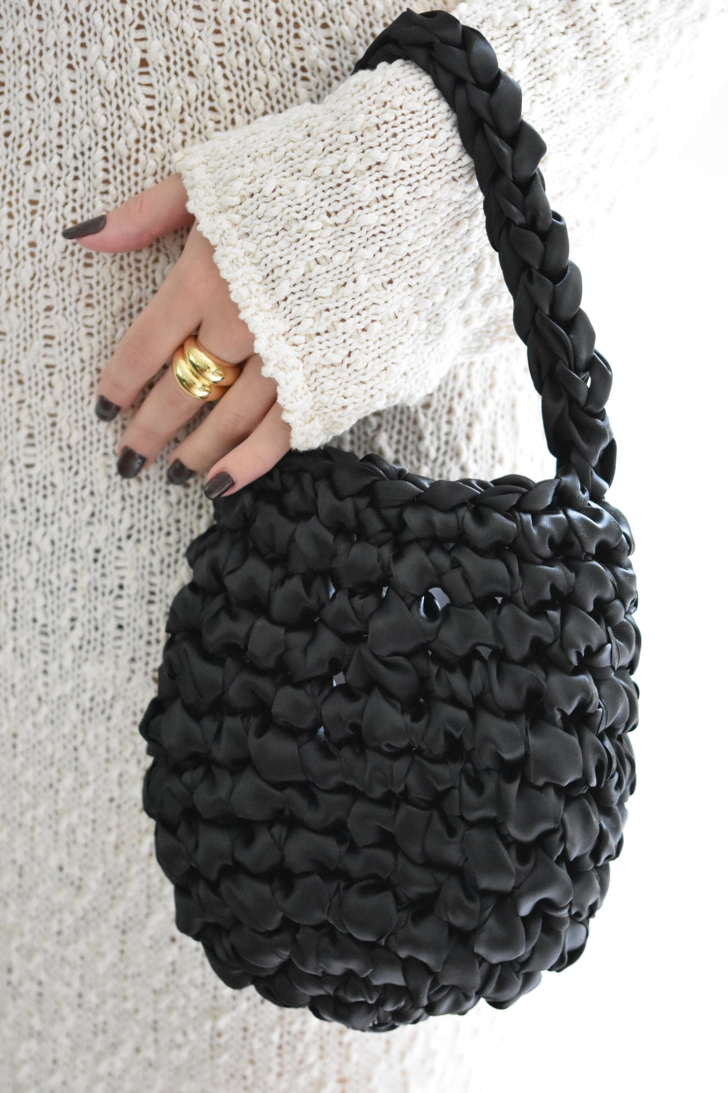 Isla de Gar Hive Bag with crocheted satin ribbon in black and Daphine Oli rings in gold.