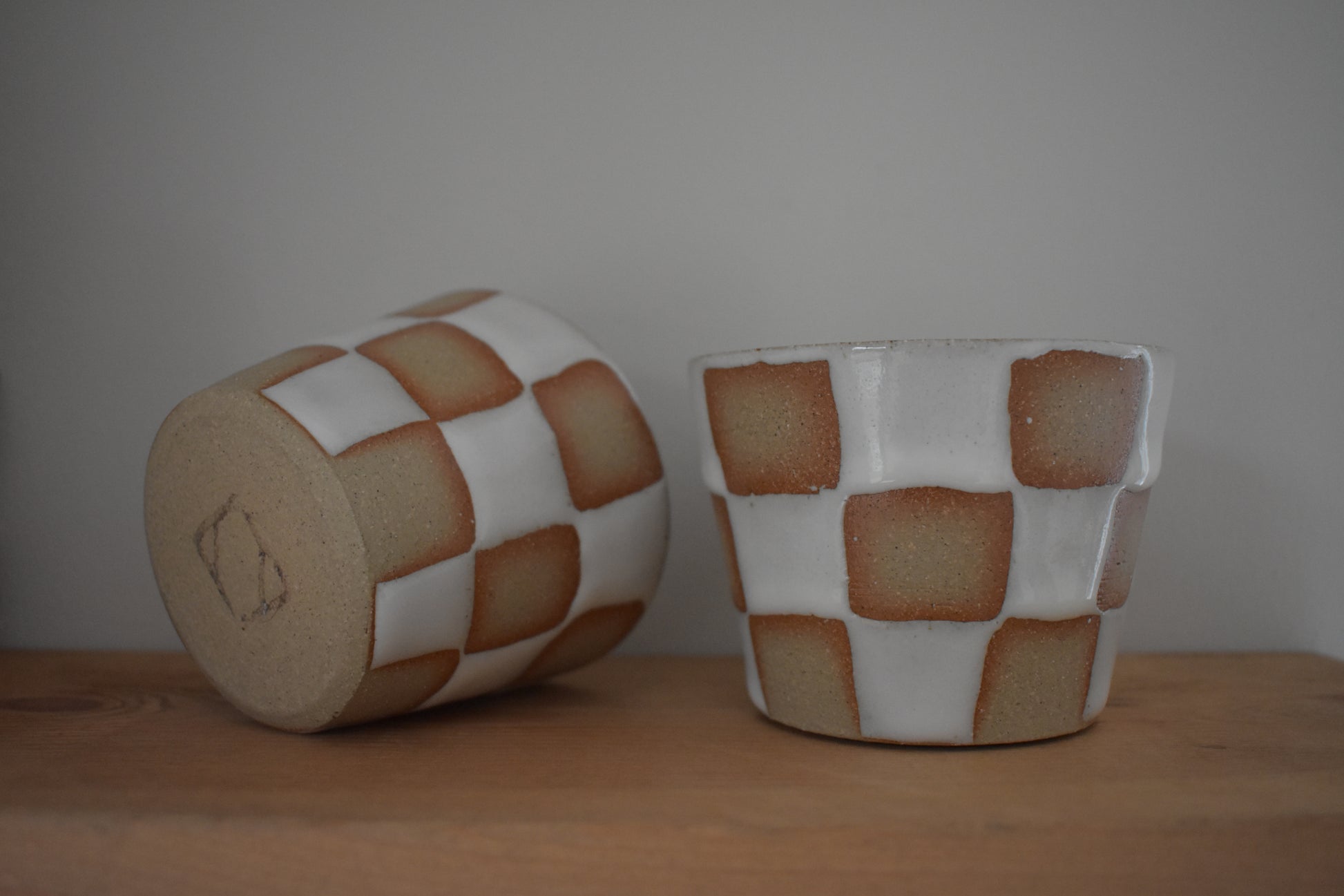 AEA Studio ceramic stoneware cups with white chequer pattern.